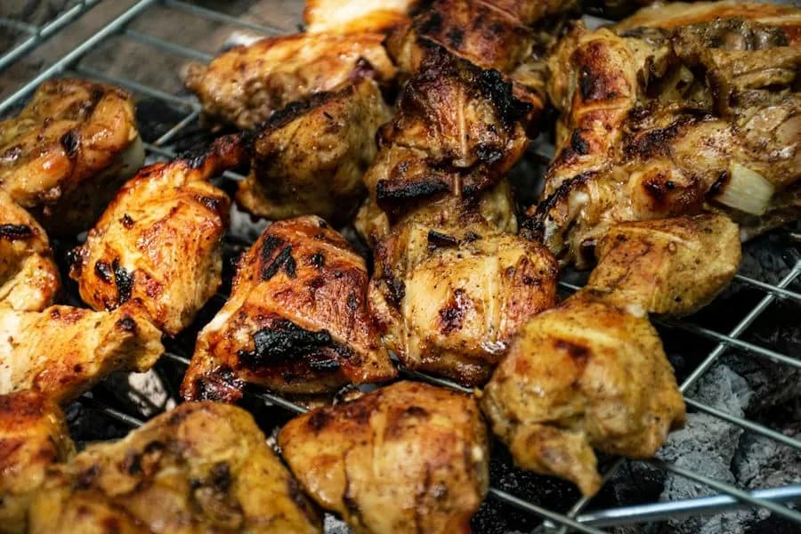 Chicken thighs browning on a grill
